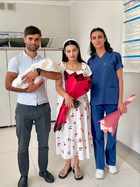 Gənc ailə yeni doğulmuş körpə ilə həkimin yanında